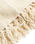 Close-up of the Sea Shell White Textured Checks Handloom Throw showcasing its checked texture and hand-rolled fringes.