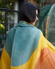 Cirq Sun Yellow Green Circle Pattern Hand Embroidered Linen Silk Handloom Scarf draped elegantly over a model.