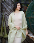 Soya Pastel Lime Green Hand Woven Soft Linen Scarf worn elegantly over a light dress against a rustic background.