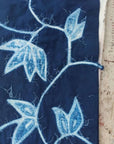 Folio Indigo Handcrafted Shibori Cotton Table Napkins ( set of 4 ) featuring intricate blue leaf patterns on dark indigo fabric.