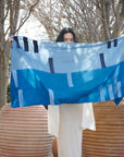 Harbor Blue Silk Merino Hand Woven Hand Embroidered Modern Artisanal Scarf displayed outdoors by a model.