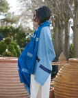 Harbor Blue Silk Merino Hand Woven Hand Embroidered Modern Artisanal Scarf displayed outdoors with a model.