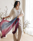 Iris Haze Blue Pink Cashmere Merino Handloom Scarf showcased by a model in a bright, elegant setting.