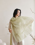 Soya Pastel Lime Green Hand Woven Soft Linen Scarf draped elegantly on a woman showcasing its translucent appeal.