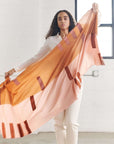Canyon Hand Embroidered Hand Woven Merino Silk Soft Scarf displayed by a model in a light-filled studio.