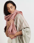 Chive Pink Green Ombre Handloom Merino Throw worn by a model, showcasing its modern design and unique colors.