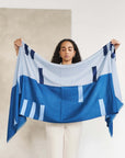 Harbor Blue Silk Merino Hand Woven Hand Embroidered Modern Artisanal Scarf held by a model showcasing its design.