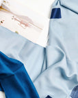 Harbor Blue Silk Merino Hand Woven Hand Embroidered Modern Artisanal Scarf draped elegantly with soft textures.