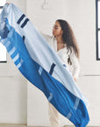 Harbor Blue Silk Merino Hand Woven Hand Embroidered Modern Artisanal Scarf displayed by model in bright indoor setting.
