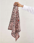 Hummus Floral Wax Block Printe Cotton Table Napkin( set of 4 ) held by hand, showcasing intricate black and red block print design.