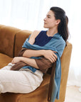 Mahogany Sky Brown Blue Ombre Linen Silk Handloom Scarf draped elegantly over a model sitting on a couch.