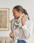 Pebble Light Gray Hand Woven Soft Linen Scarf worn by a woman, showcasing its elegant style and soft texture.