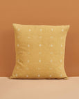 Nira Ochre Hand Spun Organic Cotton Handloom Pillow showcasing classic texture and design against a warm backdrop.