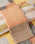 Chestnut Orange Cream Color Block Handwoven Merino Throw showcasing its unique color patterns and luxurious texture.