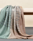 Salvia Green Brown Handwoven Merino Queen Size Bedspread styled on a bench