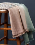 Salvia Green Brown Handwoven Merino Queen Size Bedspread styled on a stool