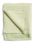Soya Pastel Lime Green Hand Woven Soft Linen Scarf folded with fringes, showcasing its translucent texture and soft color.