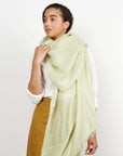 Soya Pastel Lime Green Hand Woven Soft Linen Scarf draped elegantly over a woman's shoulders.
