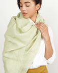 Soya Pastel Lime Green Hand Woven Soft Linen Scarf elegantly draped on a model's shoulder.