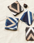 Tisa Indigo Hand Crafted Shibori Print Cotton Table Napkin set of 4 displayed on a neutral background with an artistic design.