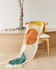 Cirq Moon Off White Multi Color Circle Pattern Hand Embroidered Linen Silk Handloom Scarf draped over a chair.