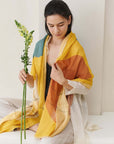 Cirq Sun Yellow Green Circle Pattern Hand Embroidered Linen Silk Handloom Scarf worn by a model holding a flower.