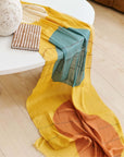 Cirq Sun Yellow Green Circle Pattern Hand Embroidered Linen Silk Handloom Scarf draped over a table with decorative items.