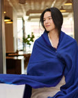 Cobalt Blue Herringbone Plush Soft Merino Handwoven Throw By Variously draped on a mode