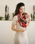 Fawn Square Silk Artisanal Scarf In Multicolor Hand Crafted Shibori Print styled elegantly around a model's neck.