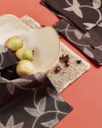 Folio Black Handcrafted Shibori Print Cotton Table Napkins ( set of 4 ) elegantly displayed with a decorative bowl.