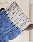 Hand Knotted Merino Textured Mari Throw Blanket in Blue Gray displayed, showcasing its serene color and unique texture.