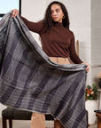 Model displaying the Alloy Dark Blue Stripes Pattern Soft Merino Linen Handloom Throw in a stylish indoor setting.