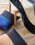Ink Black White Ombre Textured Throw In Hand Spun Merino And Hand Stitched Hem displayed with decorative pillows.