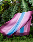 Iris Haze Blue Pink Cashmere Merino Handloom Scarf hanging outdoors with vibrant colors of blue and pink.