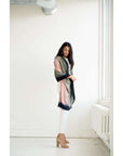 Iris Kiwi Green Pink Cashmere Merino Handwoven Scarf displayed elegantly by a model in a stylish setting.
