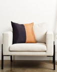 Kala Black & Gold Color Block Mulberry Silk Square Pillow on a cozy chair.