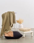 Kala Black & Gold Color Block Mulberry Silk Square Pillow with decorative throw and vase.