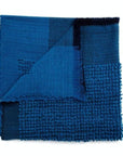 Macaroon Midnight Dark Blue Textured Merino Handloom Throw displayed in dark blue hues with varied textures.