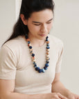 Mihika silk beaded necklace worn by a woman, showcasing handcrafted beads in soft colors, reflecting artisanal beauty.