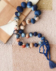 Mihika silk beaded necklace modern artisanal design with handcrafted silk beads in shades of blue and peach.