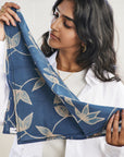 Folio Indigo Handcrafted Shibori Cotton Table Napkins ( set of 4 ) showcased by a model holding a beautifully dyed napkin.