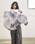 Model showcasing the Samu Black Hand Crafted Shibori Print Silk Chiffon Square Scarf in a stylish pose.