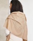 Model showcasing the Maple Beige Handwoven Hand Embroidered Classic Scarf draped over shoulders.