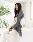 Granite Black White Ombre Linen Silk Handloom Scarf draped over a model in a stylish indoor setting.