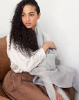 Model wearing a Pebble Light Gray Hand Woven Soft Linen Scarf, showcasing its elegance and versatility.