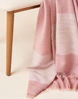 Rosa Plush Maroon Plush Merino Queen Bedspread / Large Throw draped over a chair with subtle color variations.