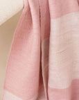 Rosa Plush Maroon Plush Merino Queen Bedspread / Large Throw showcasing soft pink herringbone weave on display.