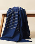 Rosewood Indigo Hand Knotted Stripes Handloom Merino Throw draped over a bench, showcasing luxurious craftsmanship and design.