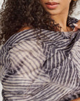 Samu Black hand crafted chiffon square scarf with unique shibori print, elegantly worn as a wrap.