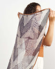 Chiffon square scarf Samu Black held by a woman showcasing its elegant shibori print design.